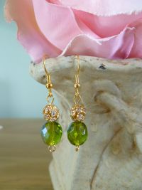 Olive coloured glass earrings with crystals strung to a gold plated mount. Price: &pound;19.98