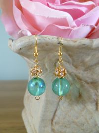 Aqua Glass and crystal earrings strung on a gold plated mount.
Box and gift wrapped included. Price: &pound;14.10