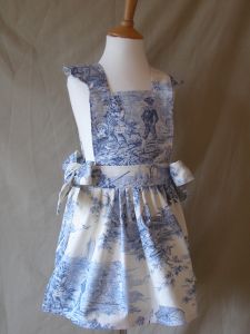 The very finest traditional thick French toile fabric in soft white & blue with scenes of traditional French children.
Finished with hand tied side bows and scalloped edge fine stitching.
All pinafore dresses are available in all of our swatches and can be worn over jeans and a long sleeve top for a casual look or equally worn underneath our co-ordinating Tutu.
Ages 2-8 years Price: &pound;34.50